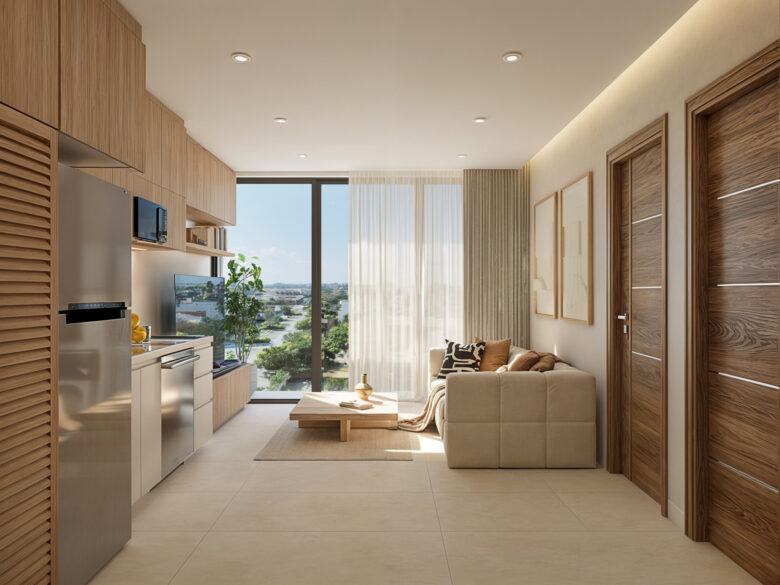 Sala y cocina integradas del desarrollo Macondo Punta Esmeralda, con mobiliario en tonos neutros, acabados de madera clara, ventanal con vista exterior y diseño minimalista, dentro de los departamentos en venta en Playa del Carmen.