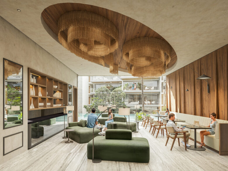 Business Center en Macondo Playacar con mobiliario contemporáneo en tonos verdes y beige, sofás, mesas de trabajo, lámparas colgantes de diseño, estanterías decorativas y vista hacia la alberca y jardines del desarrollo. Un espacio creado para los residentes de los departamentos en venta en Playa del Carmen que buscan equilibrio entre trabajo y bienestar.